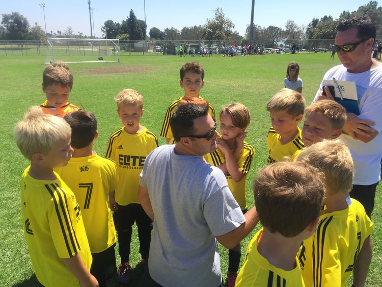 Youth soccer team huddle at ESL spring season