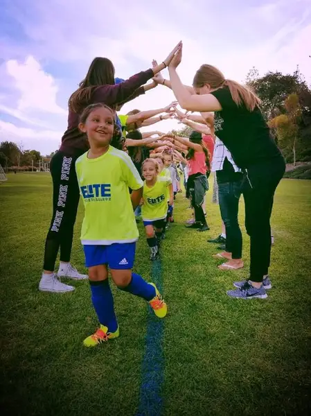 Young children playing Mini Kickers soccer