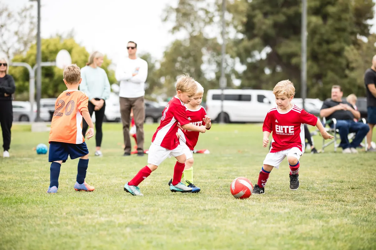 Young players chasing the ball in an Elite Soccer League 5v5 game