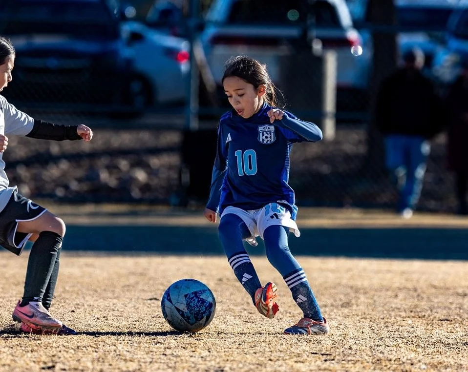 Spring soccer players developing skills on the field